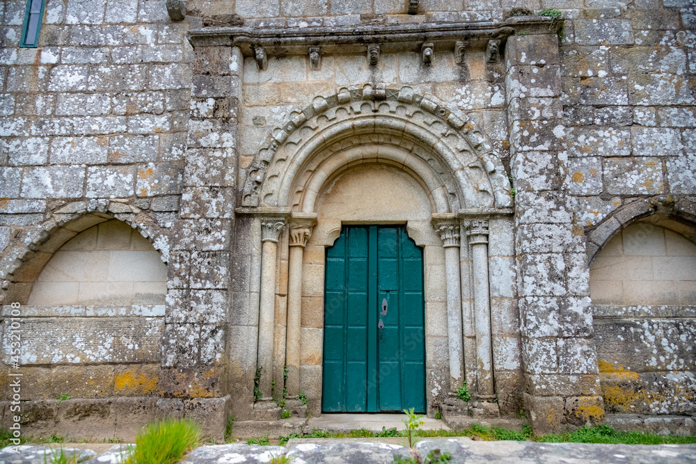 Facade of the Medieval Pilgrim Church Santa Maria de Melide with Closed Green Door on the Way of St James Pilgrimage Trail Camino de Santiago