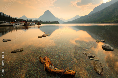 Overview of Sinopah Mountain and its reflection at sunset in Two Medicine Lake, Glacier National Park, Montana USA. photo