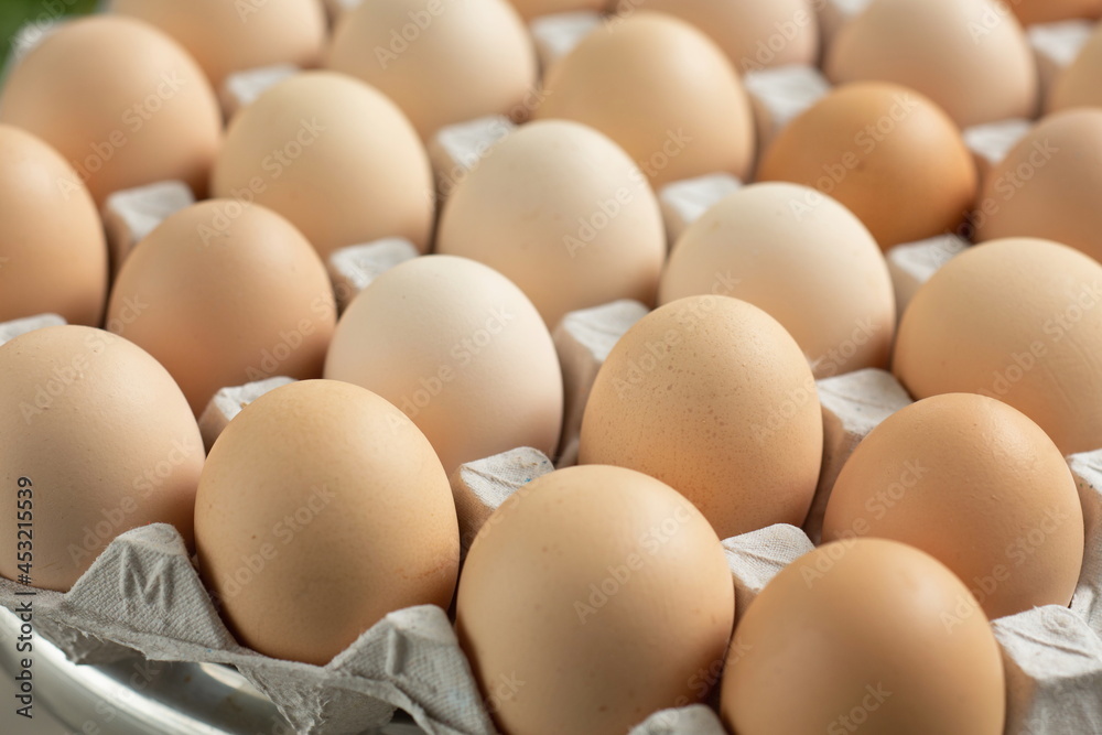 fresh hen eggs in tray paper with close up shot.