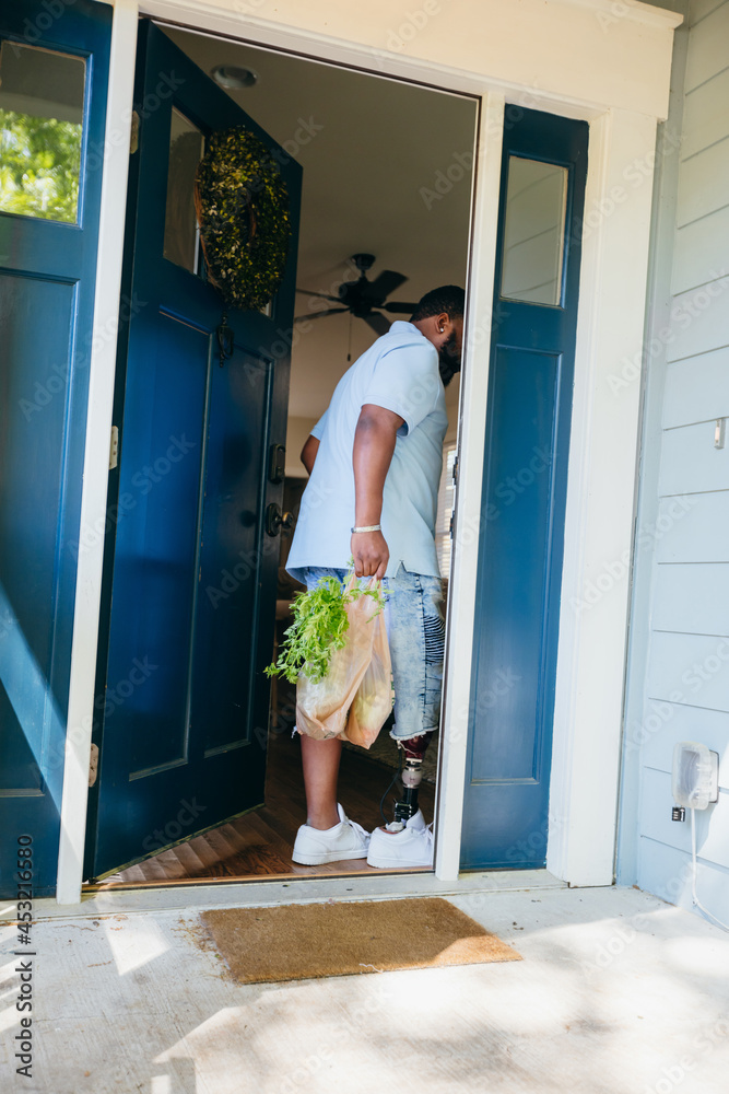 African American man brings home groceries African American man brings home groceries