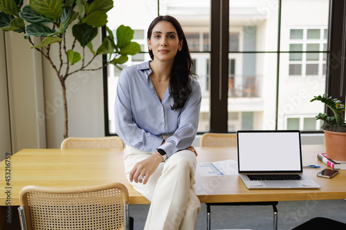 Middle Eastern Businesswoman, confident, visionary, leadership in modern office