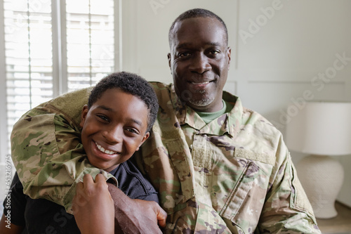 Feeling happy dad is home, family is complete, African American military, father and son