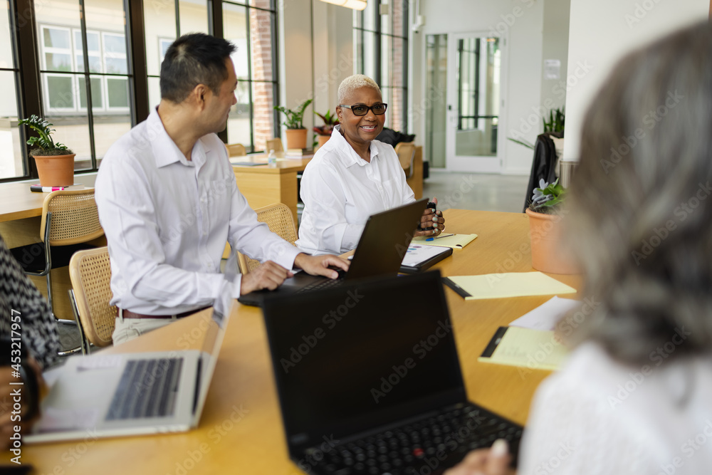 Multiethnic group having team meeting in office Multiethnic group having team meeting in office