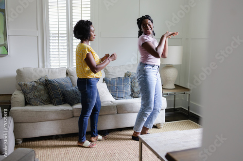 Black girl shows mom social media dance moves photo