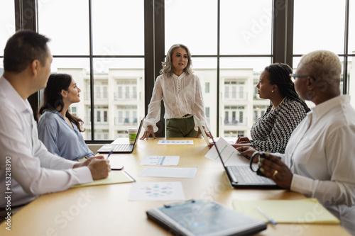 Mature Asian woman leading business team meeting photo