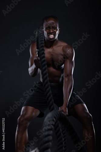 Black man doing intense sports training photo