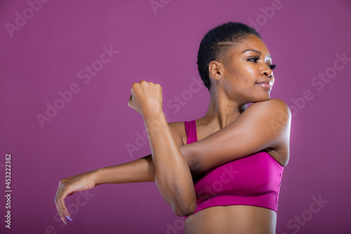 African American woman stretches her arms before workout exercise  photo