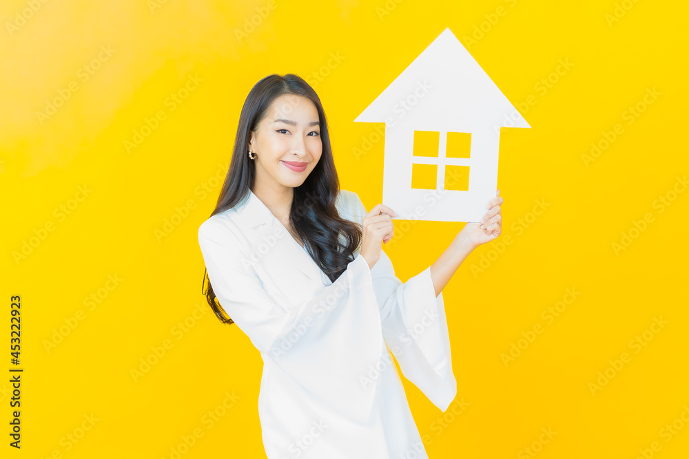 Portrait beautiful young asian woman with house or home paper sign Portrait beautiful young asian woman with house or home paper sign