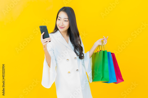 Portrait beautiful young asian woman smile with shopping bag