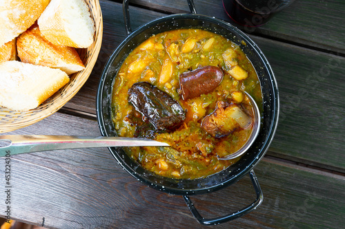 Traditional dish of Asturian cuisine Pote asturiano - thick stew with vegetables and beans added chorizo, blood sausage and bacon. photo