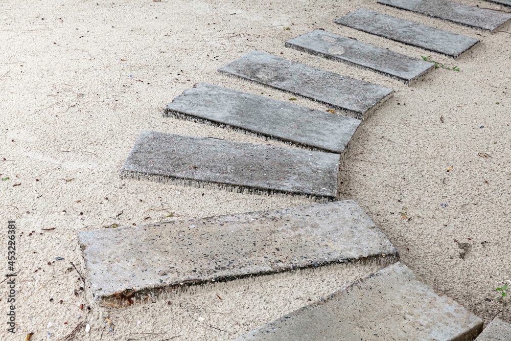 White granite walkway slabs patterned on the sandy beach White granite walkway slabs patterned on the sandy beach