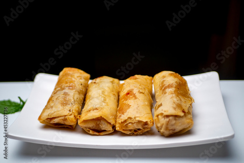 A plate of lumpia, spring rolls as Indonesian traditional food, on a white table