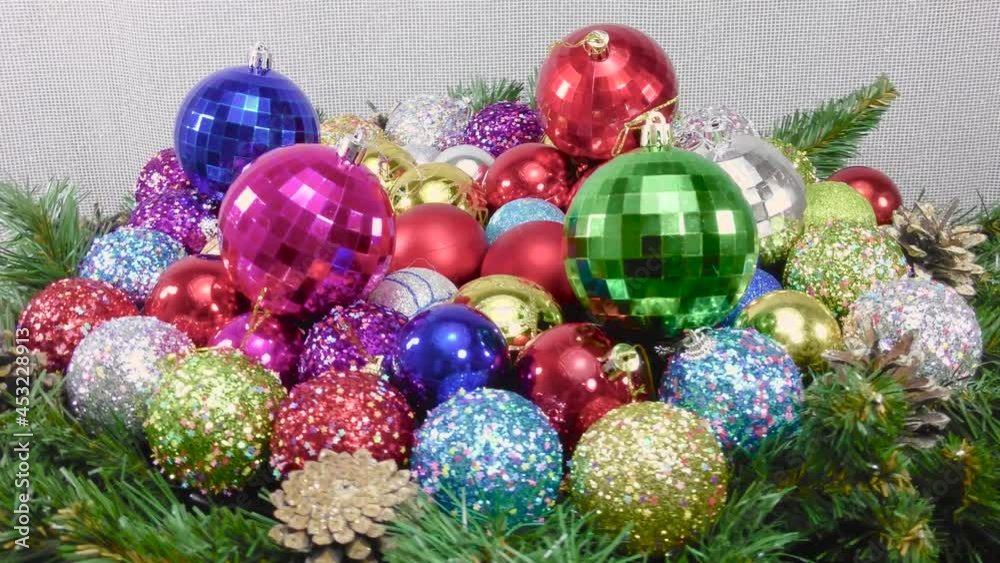 Close-up with Christmas balls moving among Christmas tree branches and cones Close-up with Christmas balls moving among Christmas tree branches and cones