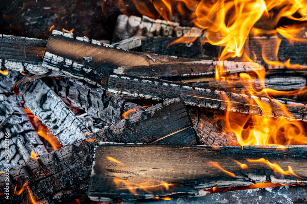 Fireplace with burning coals. Burning wood into charcoal on a barbecue.