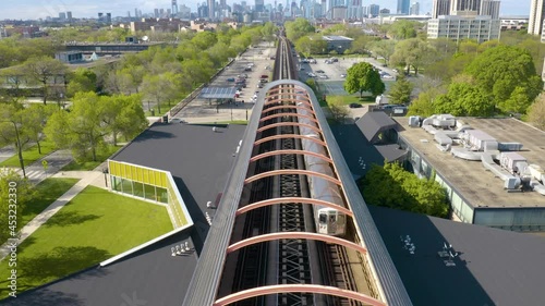 Subway Train Departing Modern Station, Chicago Skyline in Background photo