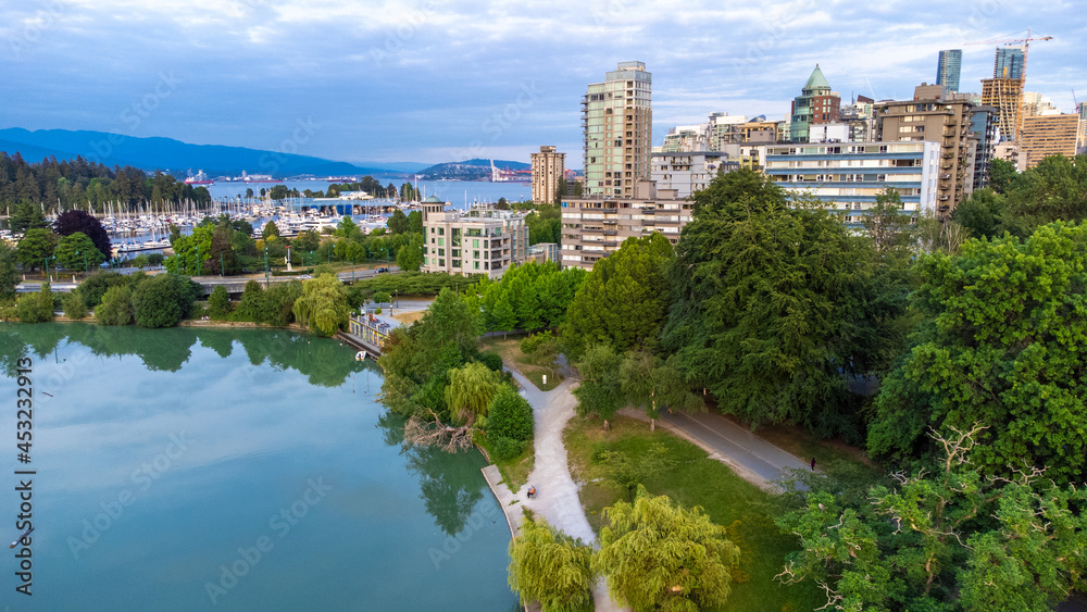 Obraz premium Aerial photo taken over Lost Lagoon, Stanley park with view towards the West End in Downtown Vancouver and the burrard inlet in the backgournd