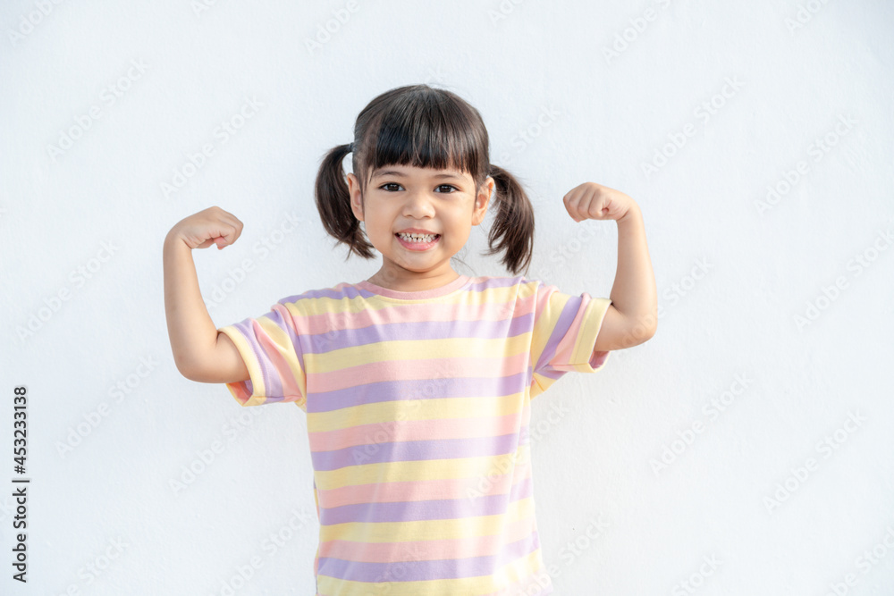 Happy Asian children showing her strong hands Happy Asian children showing her strong hands
