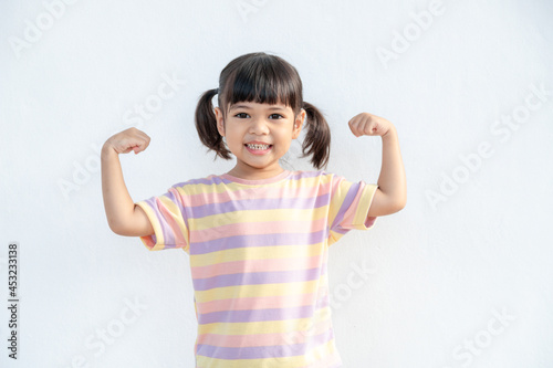Happy Asian children showing her strong hands