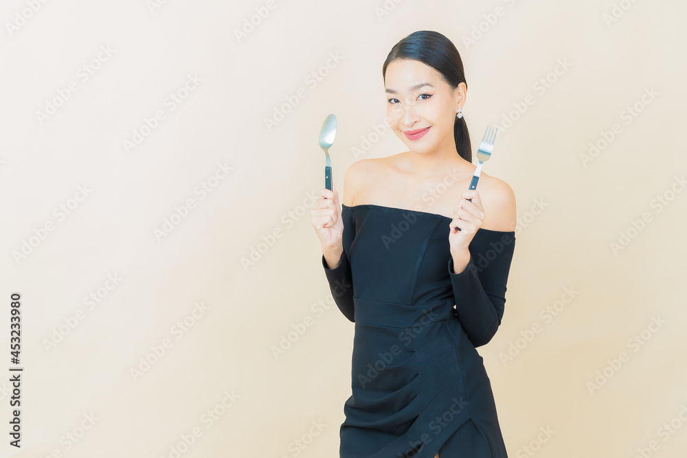 Portrait beautiful young asian woman smile with spoon and fork Portrait beautiful young asian woman smile with spoon and fork