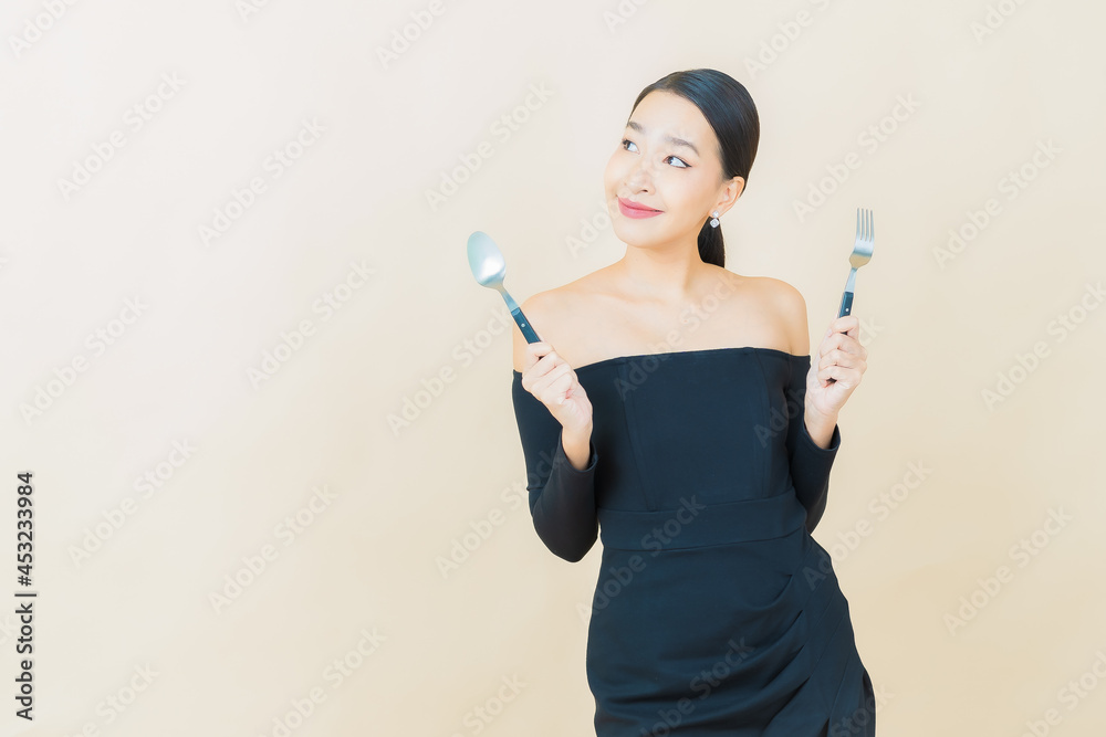 Portrait beautiful young asian woman smile with spoon and fork Portrait beautiful young asian woman smile with spoon and fork