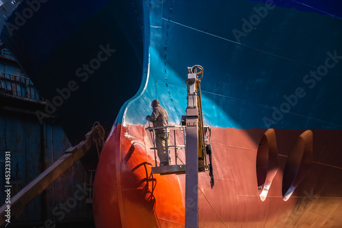 Fotografering Painting the bottom of the ship