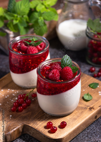 raspberry panna cotta with berries and mint, Italian dessert, home cooking. creamy dessert in a glass