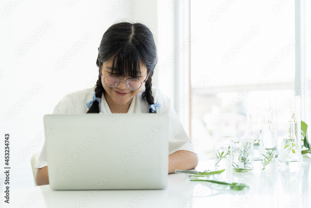 Asian girl scientists learning science and using computer laptop in the laboratory. Science and education, researcher and discovery concept Asian girl scientists learning science and using computer laptop in the laboratory. Science and education, researcher and discovery concept