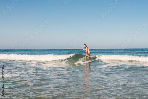 pretty young female surfer in action