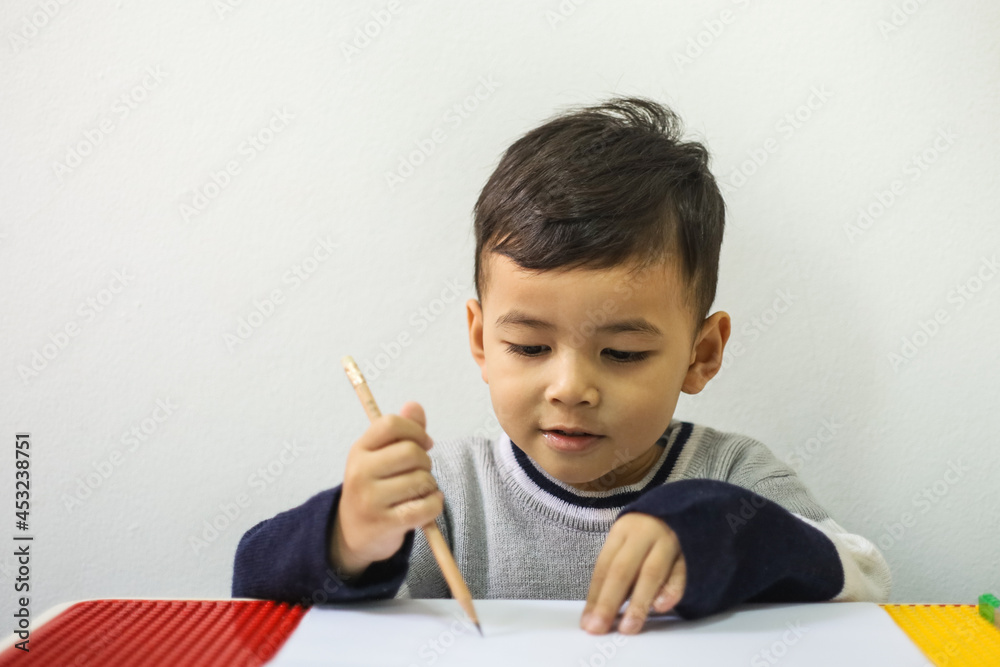 Asian children learn to write, Little Asian Child drawing at home Asian children learn to write, Little Asian Child drawing at home