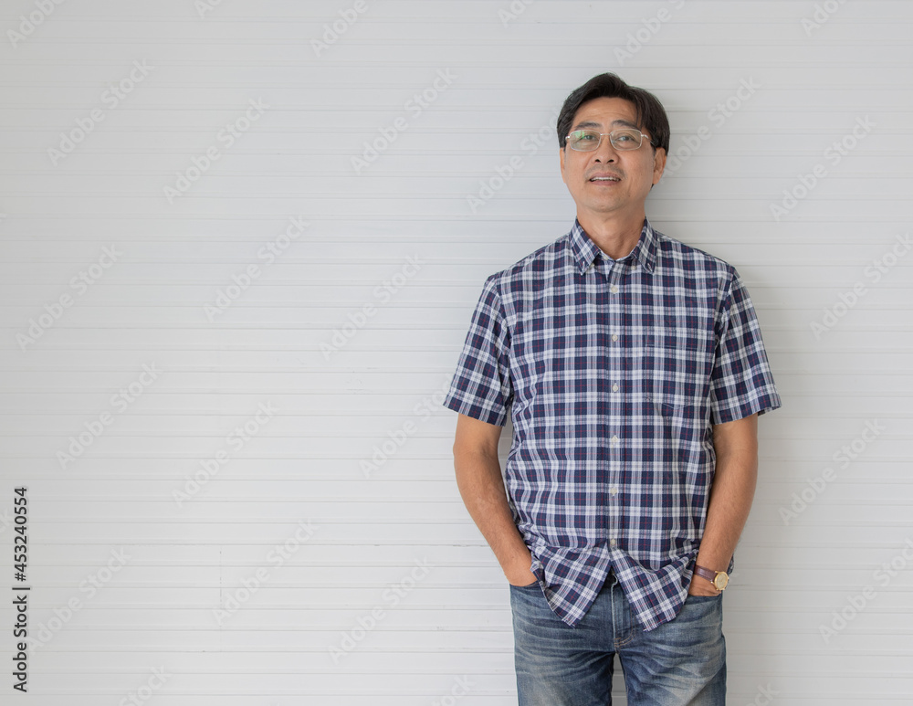 Man in Blue and White Plaid Shirt and Denim Jeans Standing on