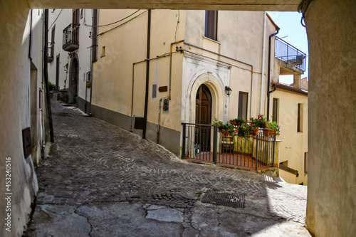 Fototapeta Naklejka Na Ścianę i Meble -  A small street between the old houses of Castelluccio Superiore, a small town in the province of Potenza in Basilicata, Italy.