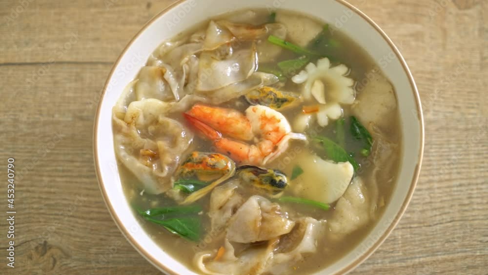 Wide Rice Noodles with Seafood in Gravy Sauce - Asian food style Wide Rice Noodles with Seafood in Gravy Sauce - Asian food style