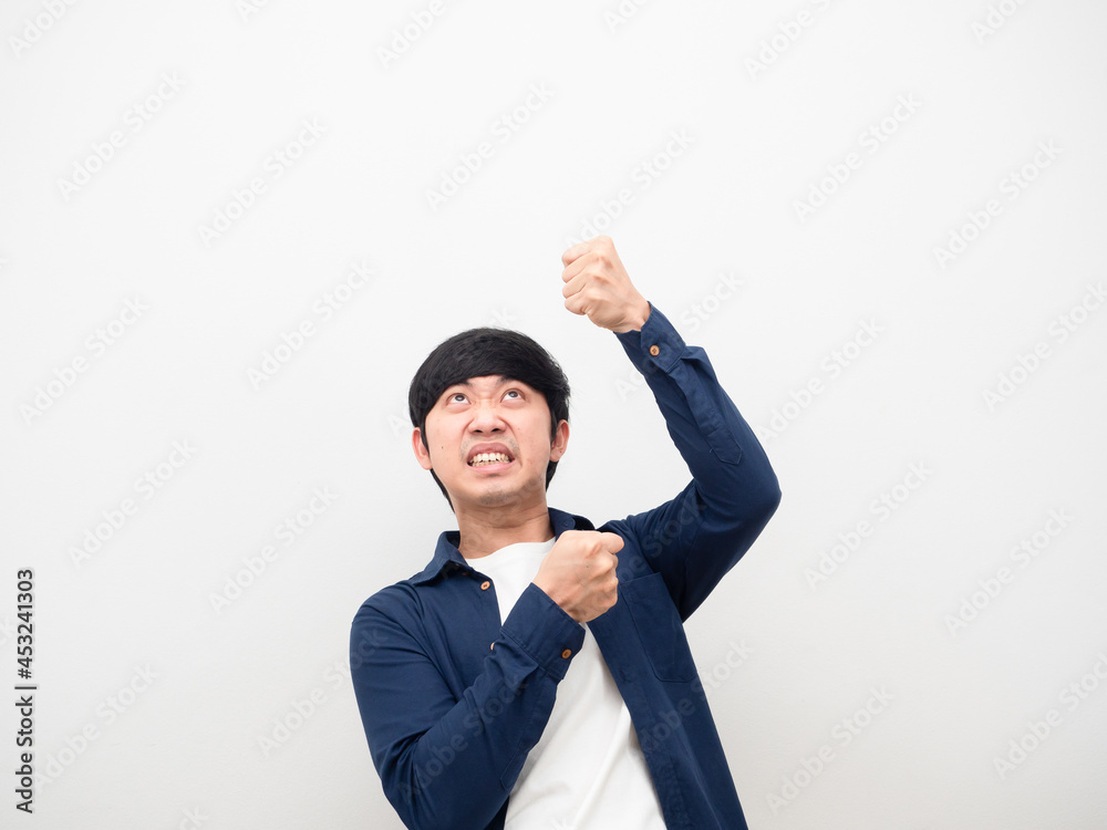 Asian man gesture pull rope down feeling heavy and serious face white background Asian man gesture pull rope down feeling heavy and serious face white background
