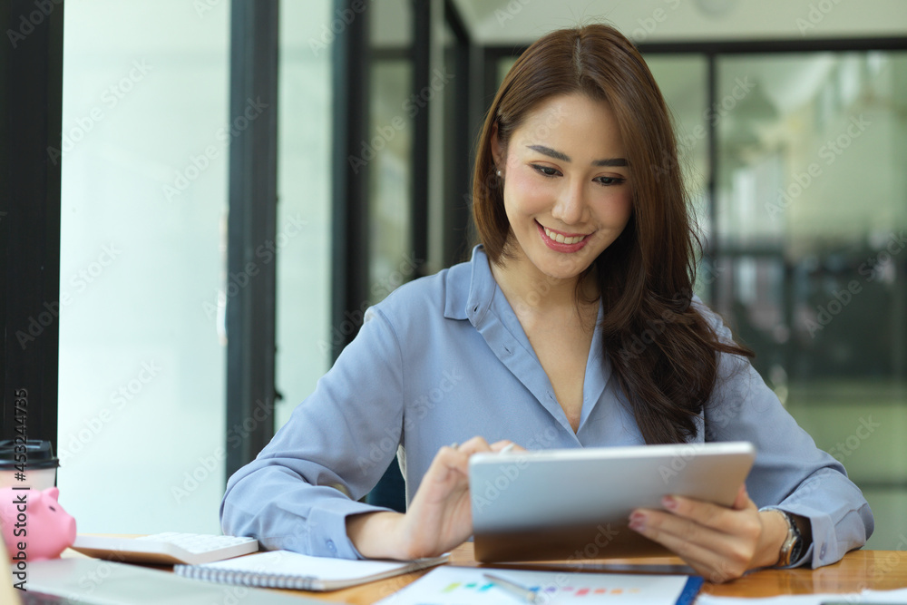 Elegant female entrepreneur using digital tablet Elegant female entrepreneur using digital tablet