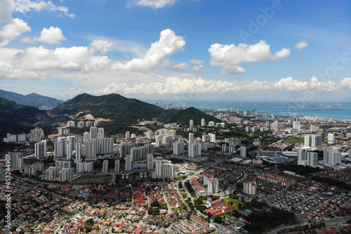 Aerial view of Bayan Lepas Industrial park, residential houses and commercial shop building on a sunny day in Penang, Malaysia. © ltyuan