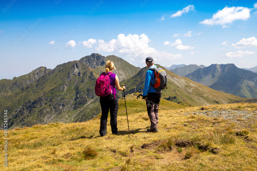 Hiking in the Carpathians: Hikers in the Fogarasch Mountains, Romania. The mountains are crossed by the Transfogarasch High Road