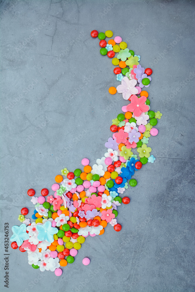 small and colorful sweet candies on gray background small and colorful sweet candies on gray background