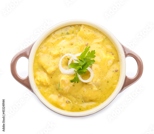 Pot of tasty chicken curry on white background