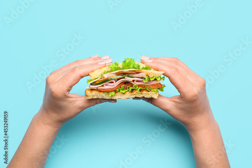 Female hands with tasty san...