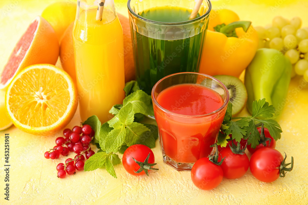 Glasses with healthy juice, fruits and vegetables on color background Glasses with healthy juice, fruits and vegetables on color background