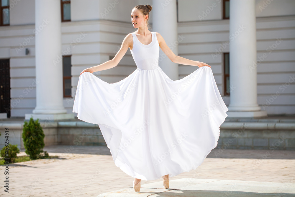 Fototapeta premium young ballerina dancing in the street