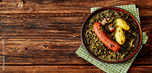 Fresh braised or boiled kale with spicy German sausage photo