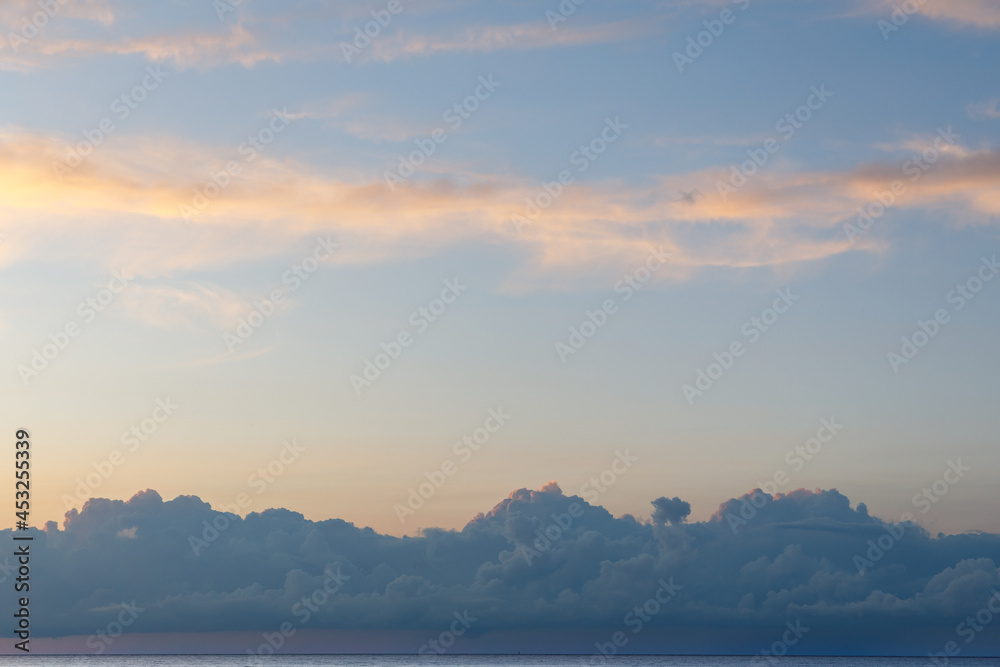 Blue sky with white clouds over the sea