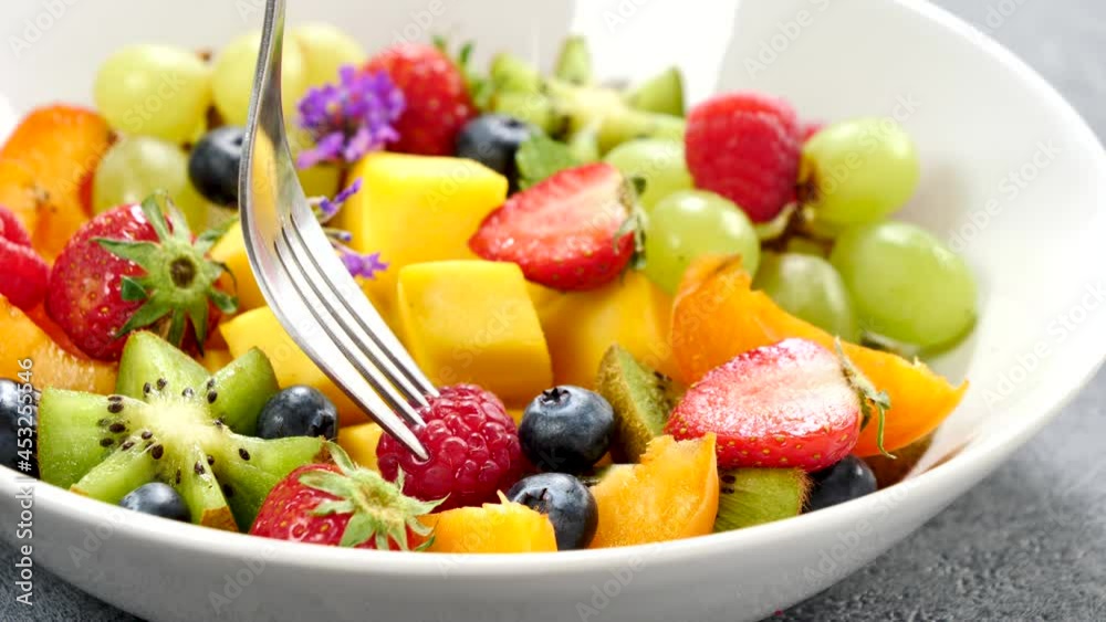 eating fresh mixed fruit salad eating fresh mixed fruit salad