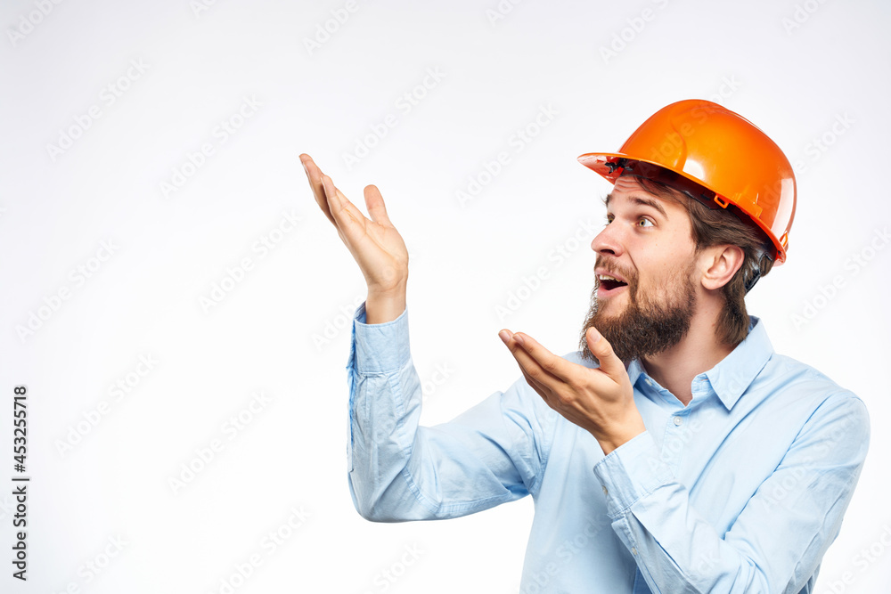 emotional man orange helmet on the head Studio hand gesture
