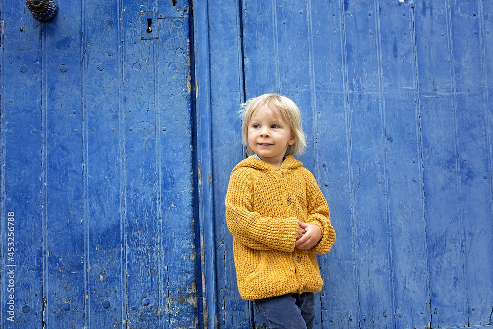 Child, boy walking in a beautiful small village street in France Child, boy walking in a beautiful small village street in France