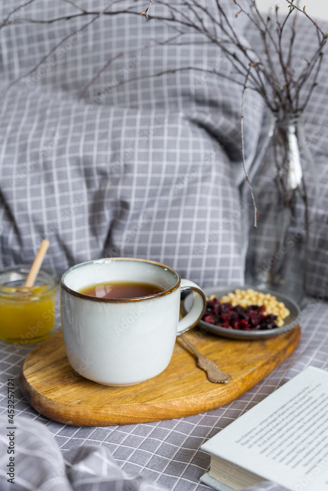 Tea with cranberries, honey and pine nuts. Healthy breakfast with a book. Tea with cranberries, honey and pine nuts. Healthy breakfast with a book.