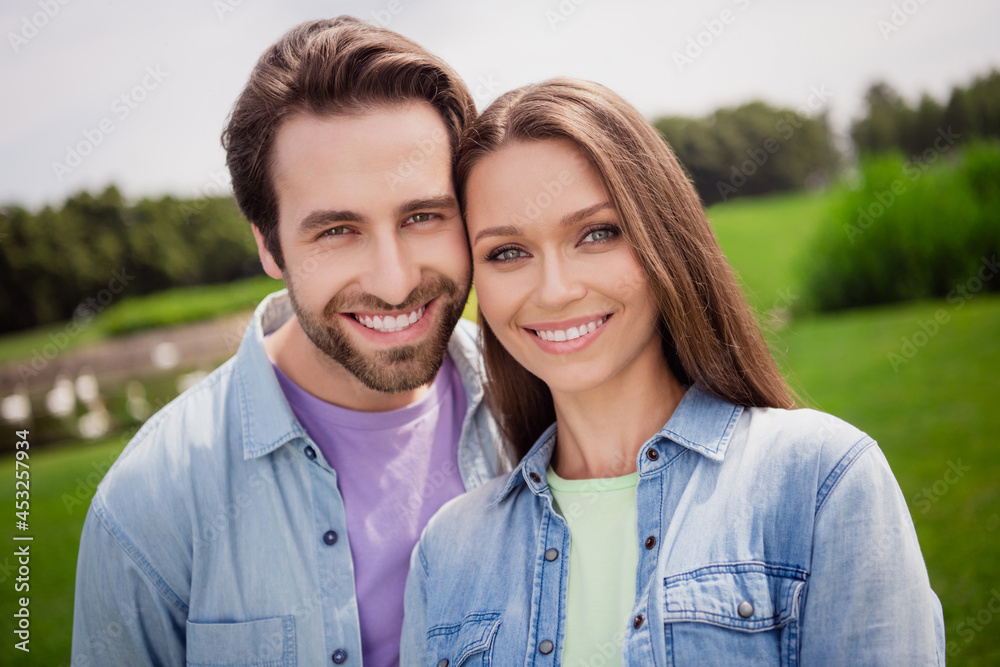 Portrait of good mood smiling couple relaxing outdoors in park countryside have romantic date outside wear denim shirt Portrait of good mood smiling couple relaxing outdoors in park countryside have romantic date outside wear denim shirt