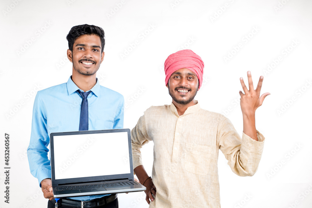 Young indian officer showing laptop screen with farmer on white background. Young indian officer showing laptop screen with farmer on white background.