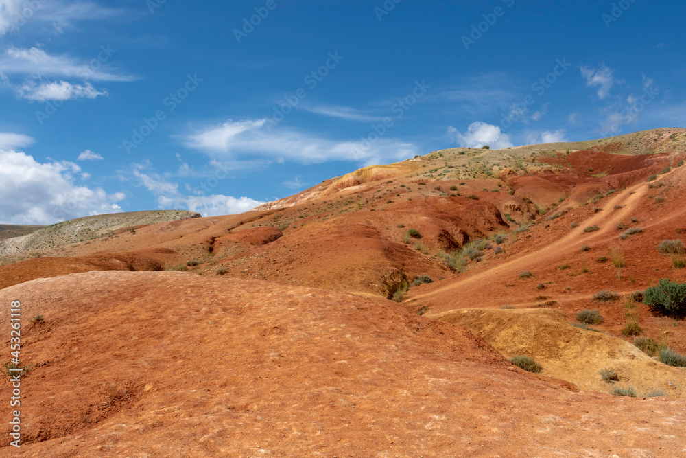 the slope of a small mountain of red sandstone the slope of a small mountain of red sandstone